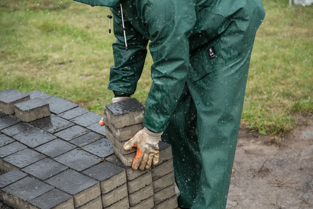 A Bravo Brothers crew member setting pavers by hand