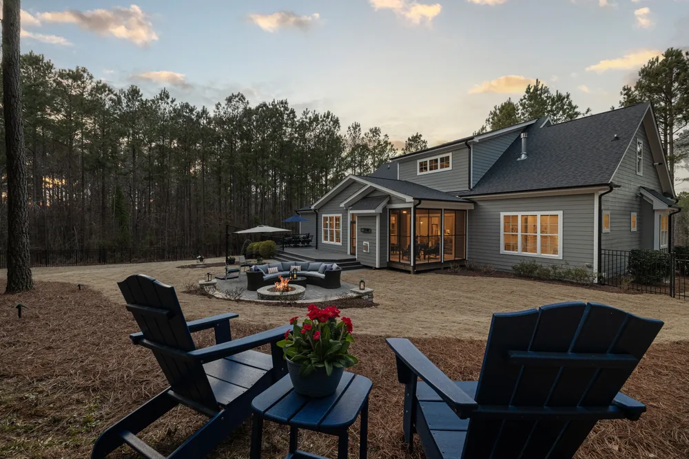 The same backyard finished with a paver terrace, fire pit and planting