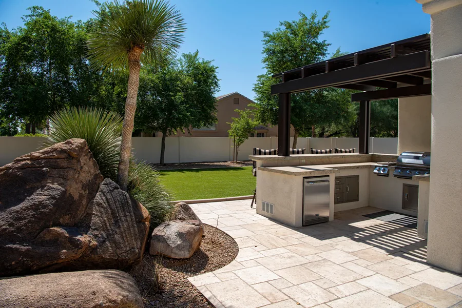 An outdoor kitchen built into a paved patio